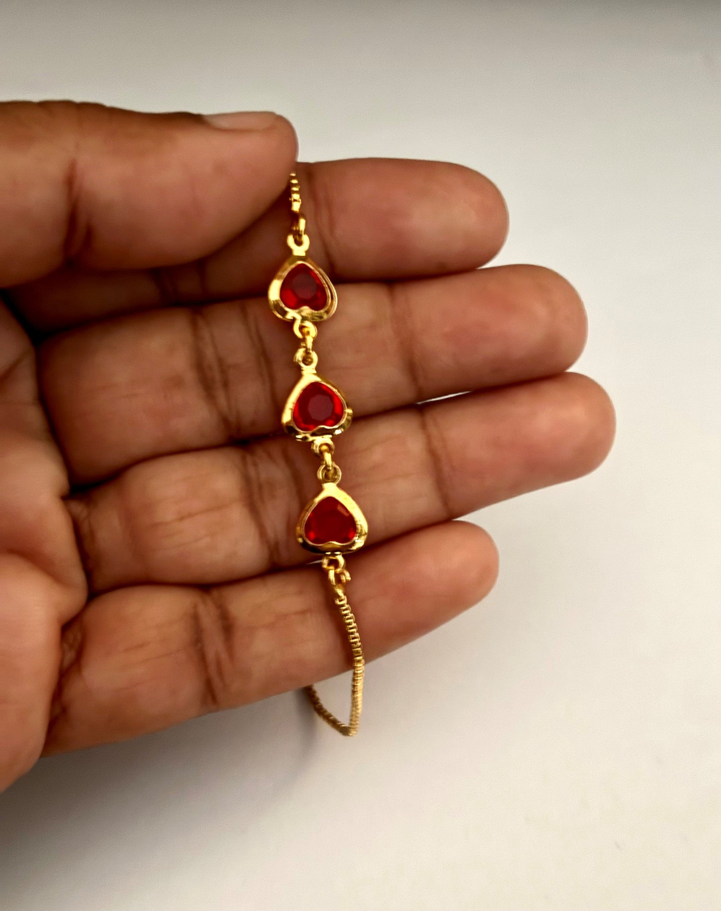 Gold-Plated Bracelet with Three Red Heart Stones