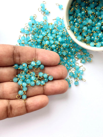 Faceted Baby Blue Charms with Golden Wire