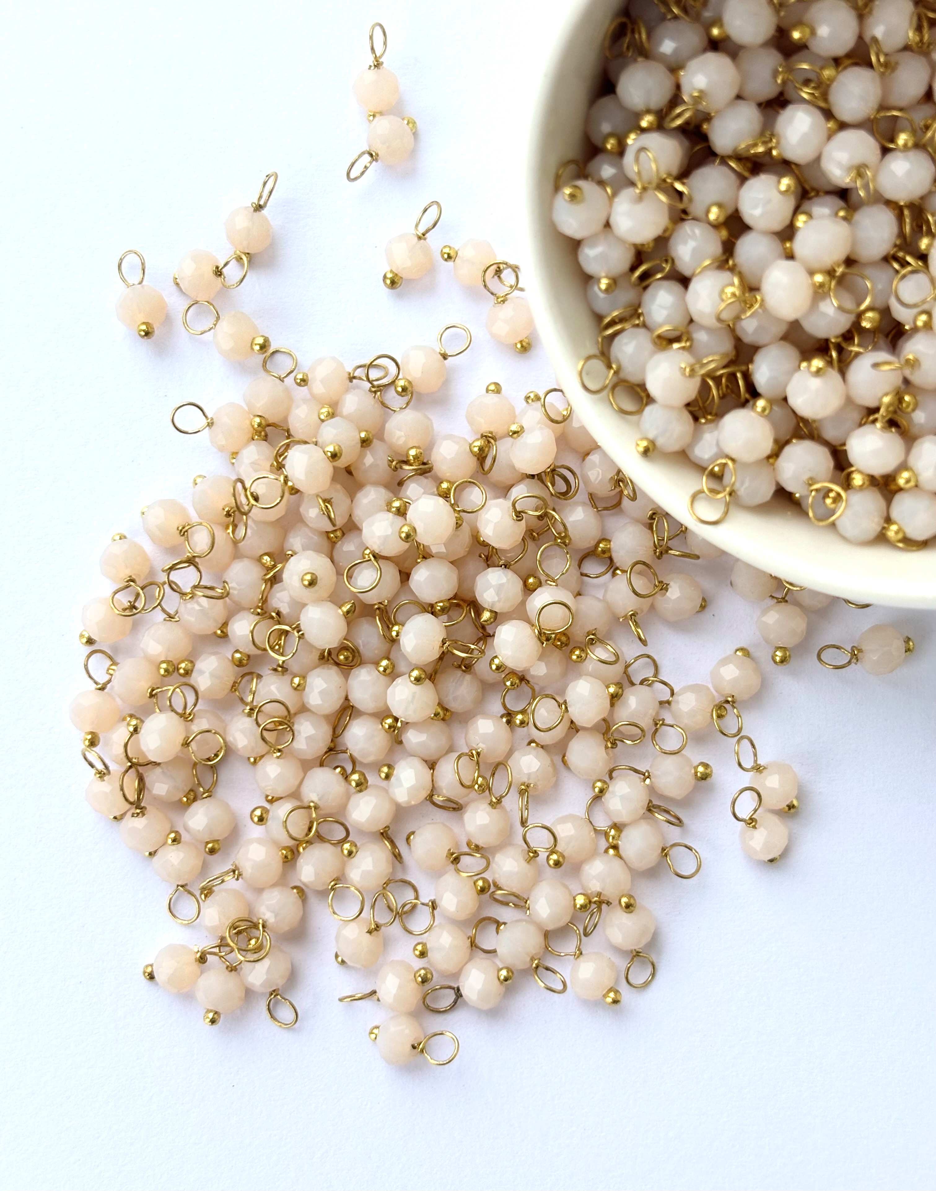 Faceted Almond Cream Charms with Golden Wire