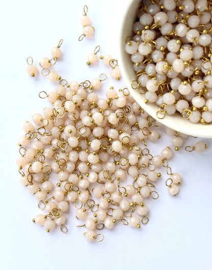 Faceted Almond Cream Charms with Golden Wire