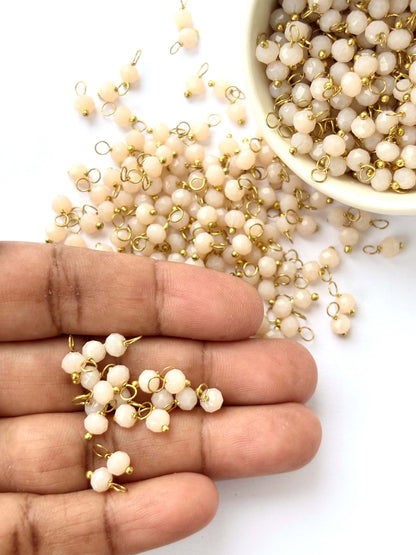 Faceted Almond Cream Charms with Golden Wire