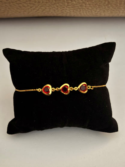 Gold-Plated Bracelet with Three Red Heart Stones