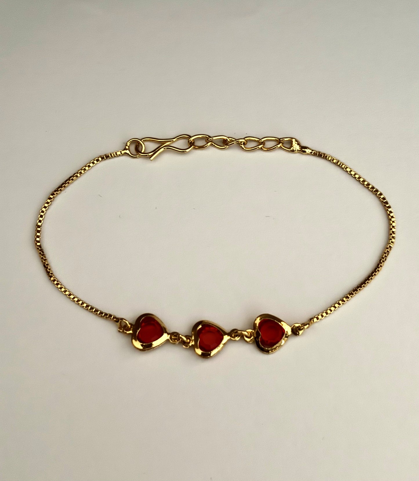 Gold-Plated Bracelet with Three Red Heart Stones